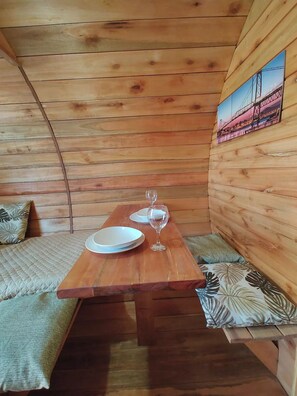 Enjoy a quiet meal at this compact room's dining area, featuring a table and bench seating.
