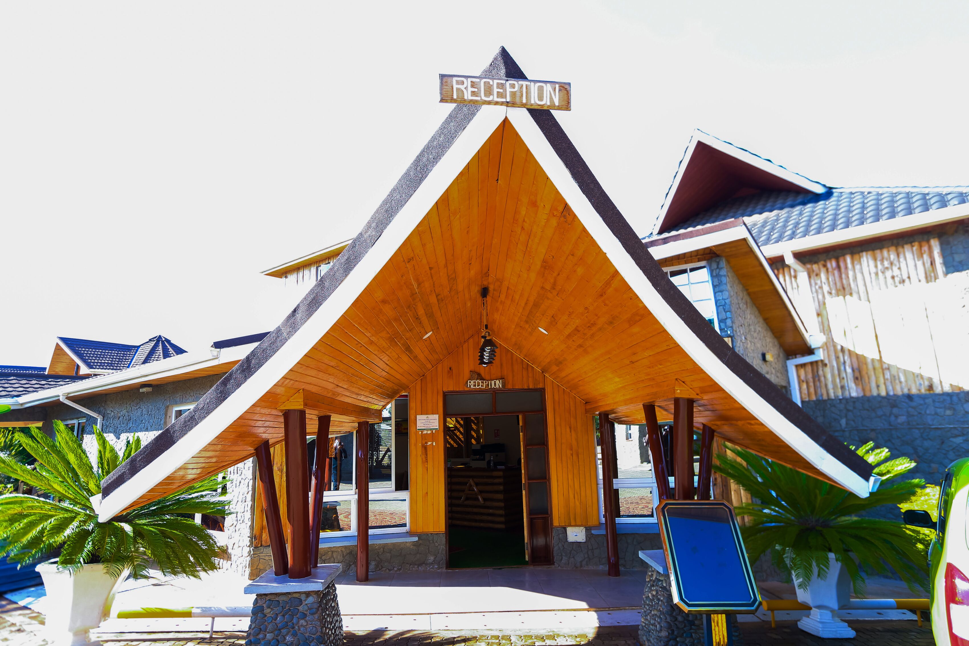 A reception area with a wooden roof and a sign above the door.