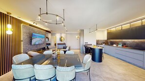 Una cocina moderna con una isla grande, electrodomésticos integrados y una encimera elegante.