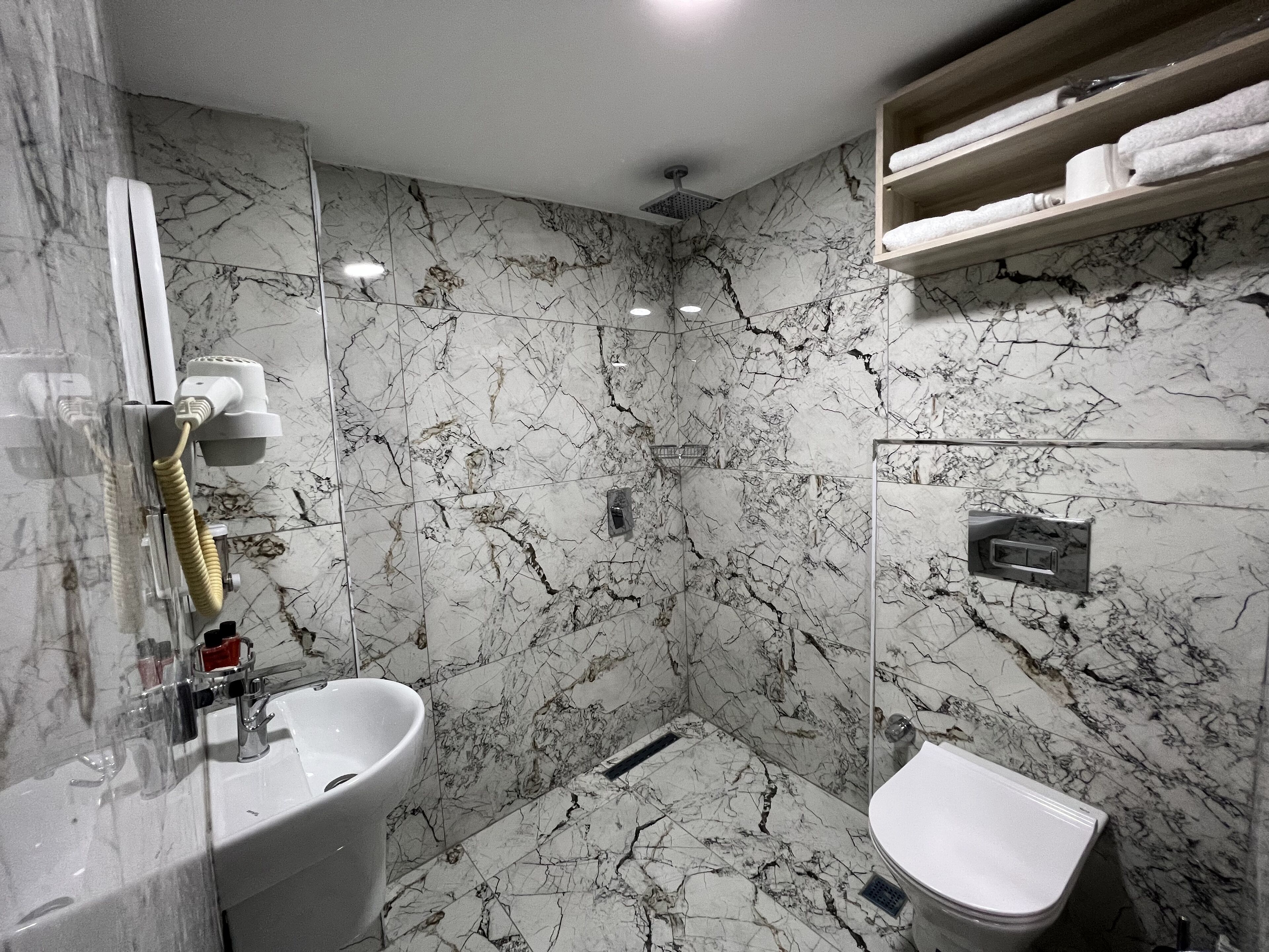 Shower, hair dryer, slippers, towels