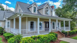 A two-story house with a front porch, a chimney, and a mailbox. - Bama Farmhouse - Beautiful Pool Area! (Tuscaloosa)