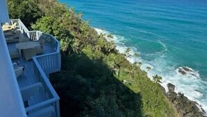 A balcony with outdoor furniture overlooking a coastal ocean view. - Villa Mangorosa (St Thomas)