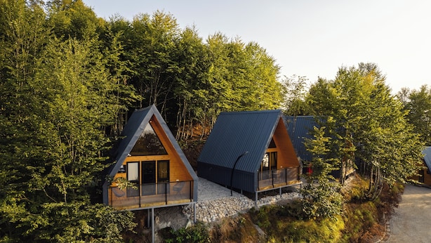 A modern cabin with a sloped roof, wooden exterior, and a glass balcony. - Chalet Kvirike (Kobuleti)