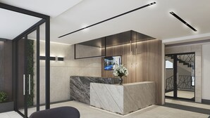 A modern reception area with a marble counter, wooden paneling, and a large mirror. - Apartments by Bor (Zlatibor)