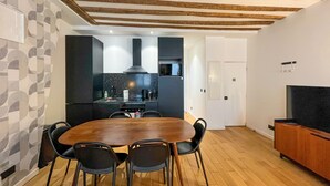A modern kitchen with a dining area.