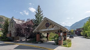 The entrance to Cimarron Lodge with a clear view of the surrounding mountainous landscape.
