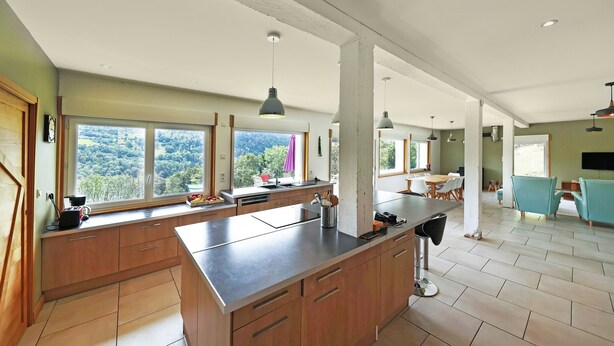 A spacious kitchen with large windows, a central island, and a dining area with teal chairs. - La Bergerie du Pré de l'Orme - Avec vue montagne (La Bresse)