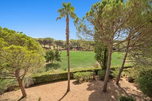 Escape to a serene outdoor oasis with lush trees and a beautifully manicured lawn.