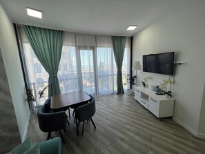 Deluxe Apartment | Living area | 40-inch Smart TV with cable channels - Holiday Lux Sea Towers Batumi (Batumi)