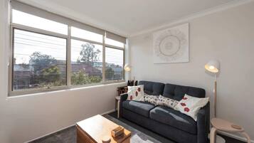 Basic Apartment, 1 Queen Bed | Living area | TV