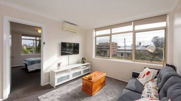 Basic Apartment, 1 Queen Bed | Living area | TV