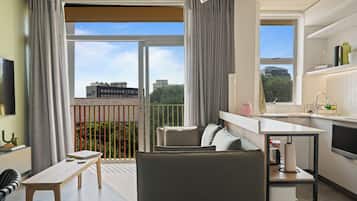 Grand Studio | Living area | 50-inch flat-screen TV with cable channels, Netflix, streaming services