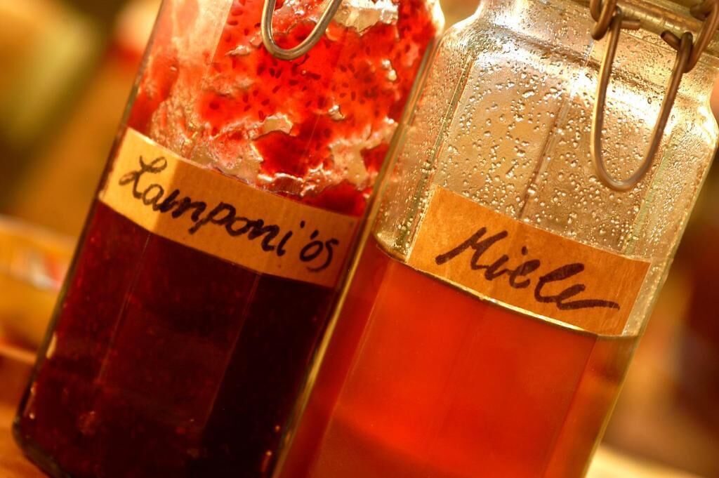 Two glass bottles with metal clasps, one labeled "Lampioni's" and the other "Hiel."