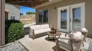 An outdoor patio with a white sofa, wicker chairs, and a round table. - Perfect location close to Zion! (La Verkin)