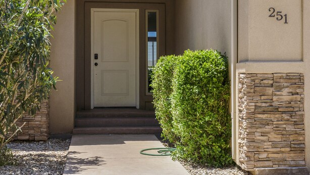 A beige building with a white door, number 251, and a stone wall. - Perfect location close to Zion! (La Verkin)