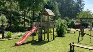 A playground with a slide, a climbing structure, and a swing set. - Quinta com Piscina Rodeada da Belíssima Paisagem do Alto Minho (Ponte de Lima)