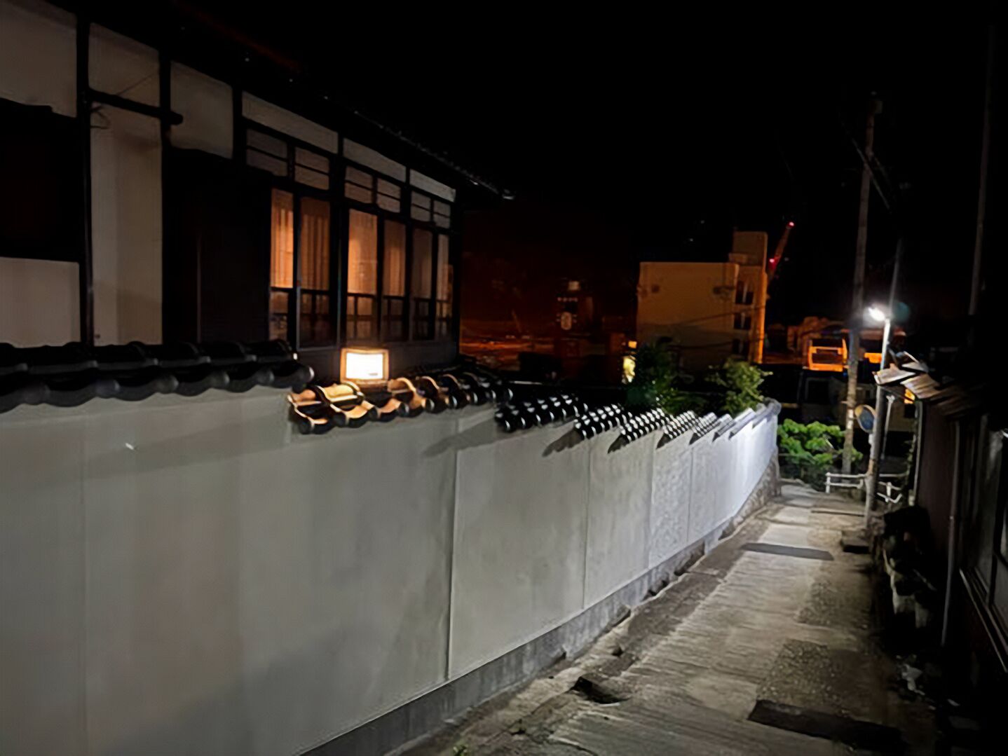 A traditional Japanese building with a row of bicycles parked outside.