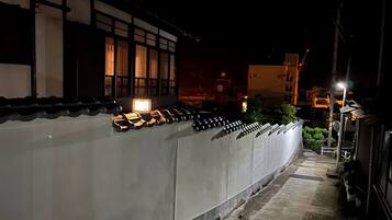 A traditional Japanese building with a row of bicycles parked outside.