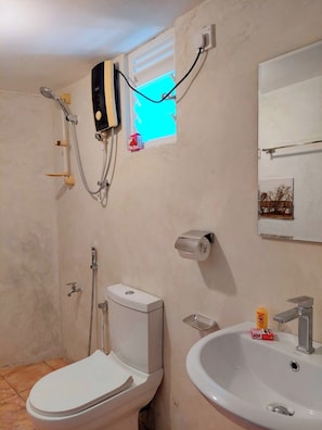A bathroom with a toilet, sink, and shower. - Villa by Tamarind Shade (Talalla)