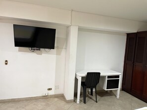 Standard Triple Room | Living area | 43-inch flat-screen TV with cable channels