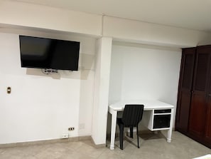 Standard Triple Room | Living area | 43-inch flat-screen TV with cable channels