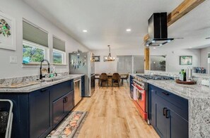 Enjoy cooking in this well-equipped kitchen with a central island, gas stove, and ample counter space.