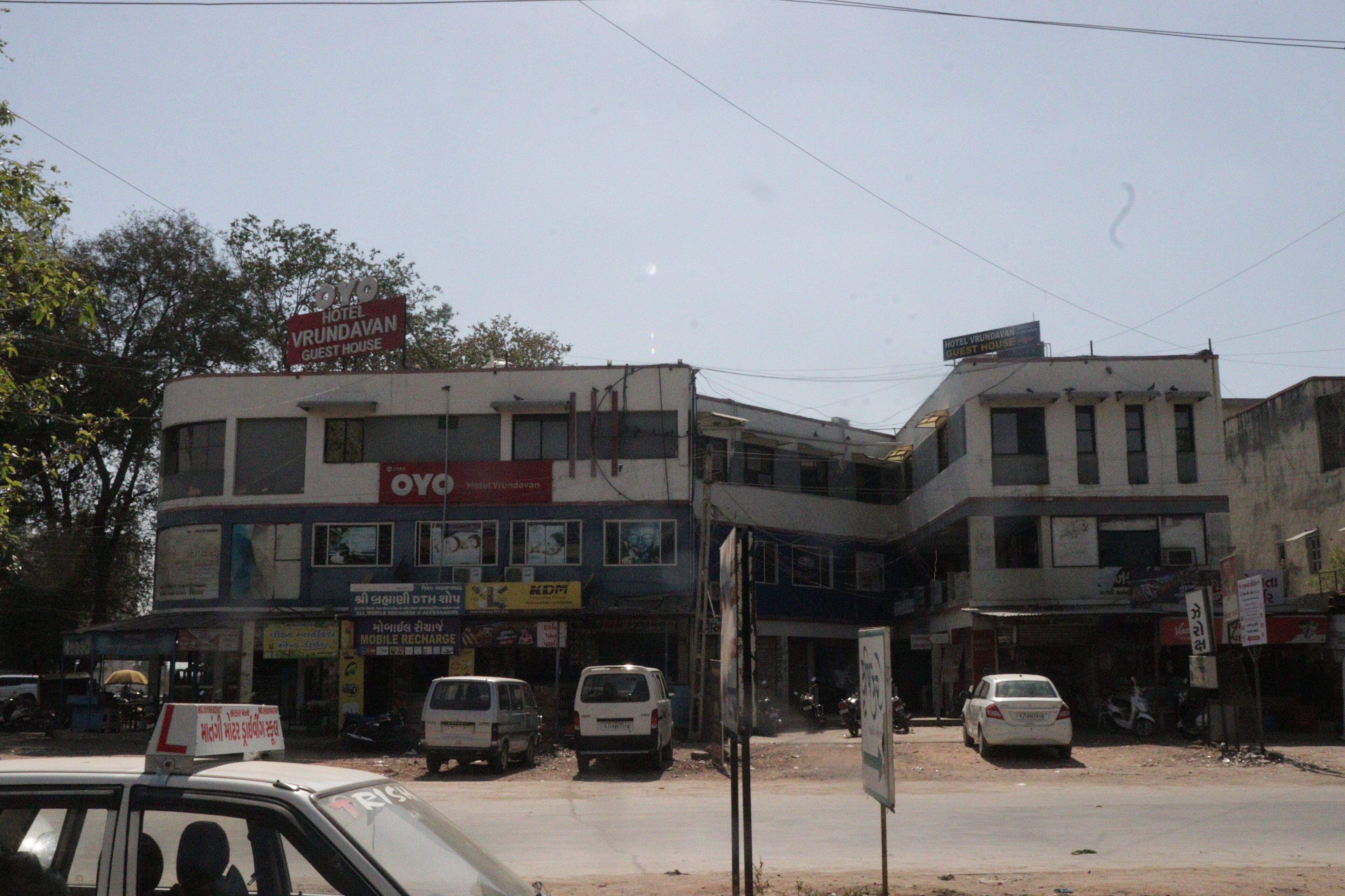A building with multiple signs, including one for a hotel and another for a guest house.