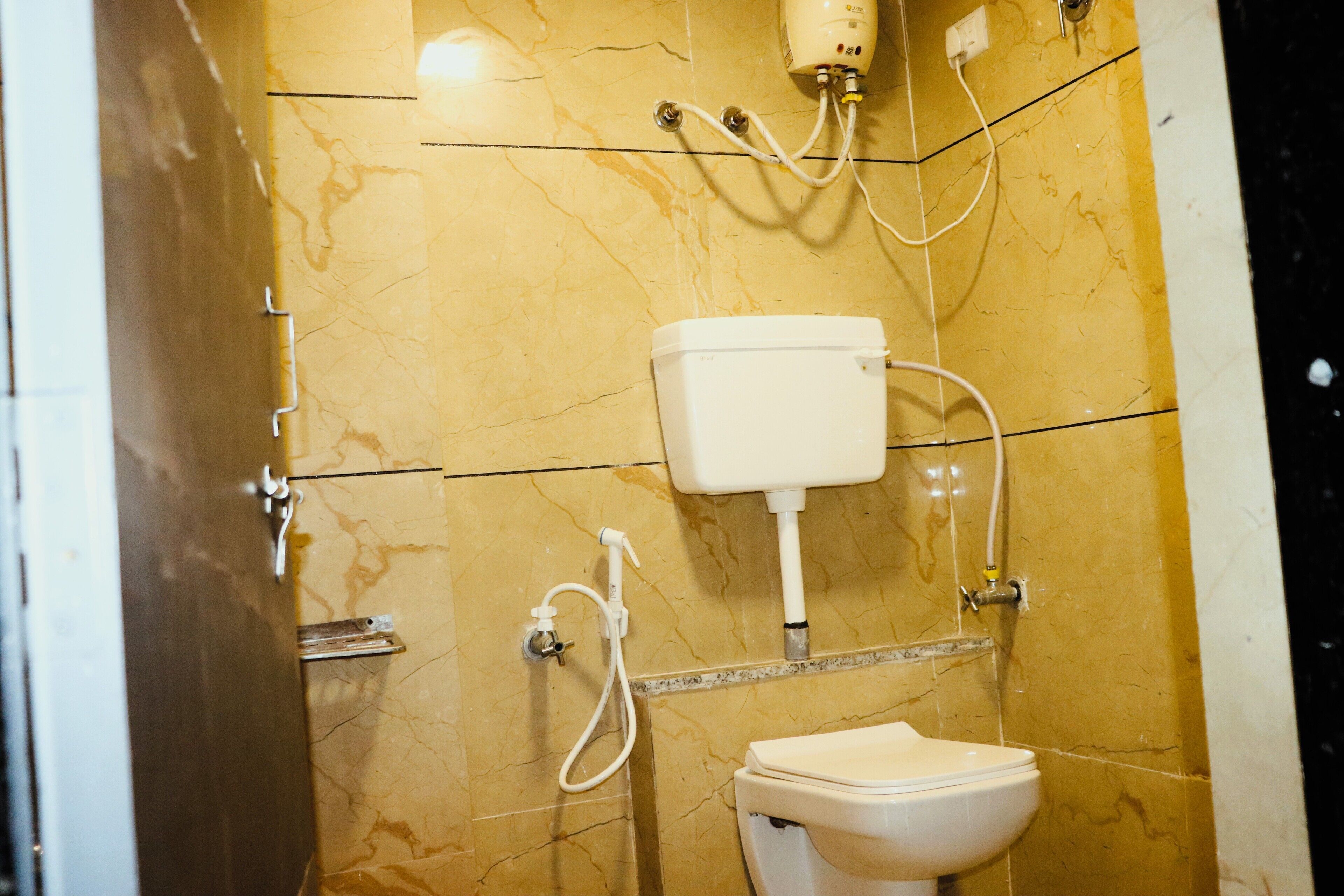 A bathroom with a toilet, a sink, and a shower.