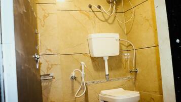 A bathroom with a toilet, a sink, and a shower.
