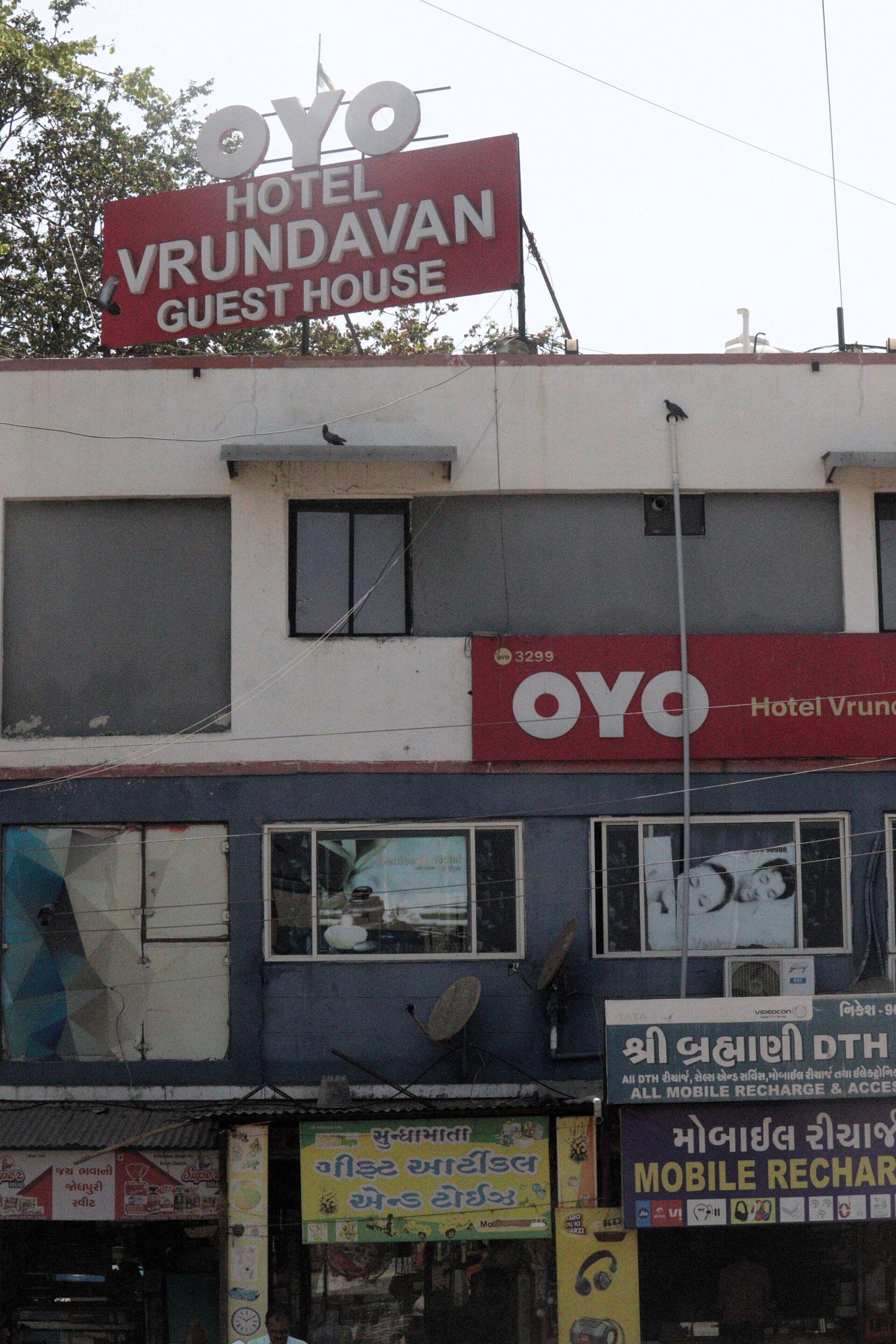 A building with a prominent sign for 'OYO Hotel Vrundavan Guest House'.