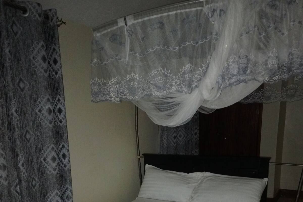 Desk, laptop workspace, bed sheets