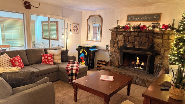 A cozy living room with a fireplace, a sofa, and a coffee table.
