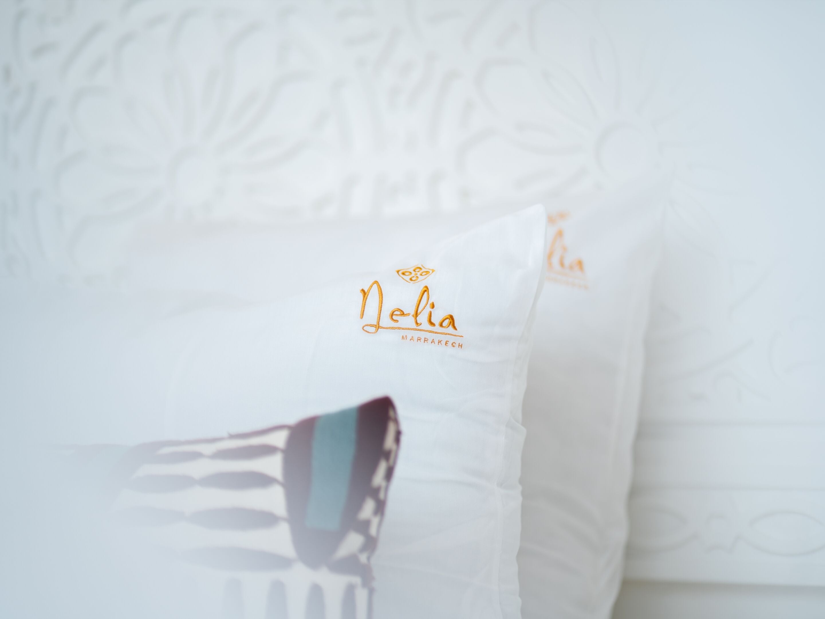 A pillow with the text 'Nelia Marrakesh' on it.