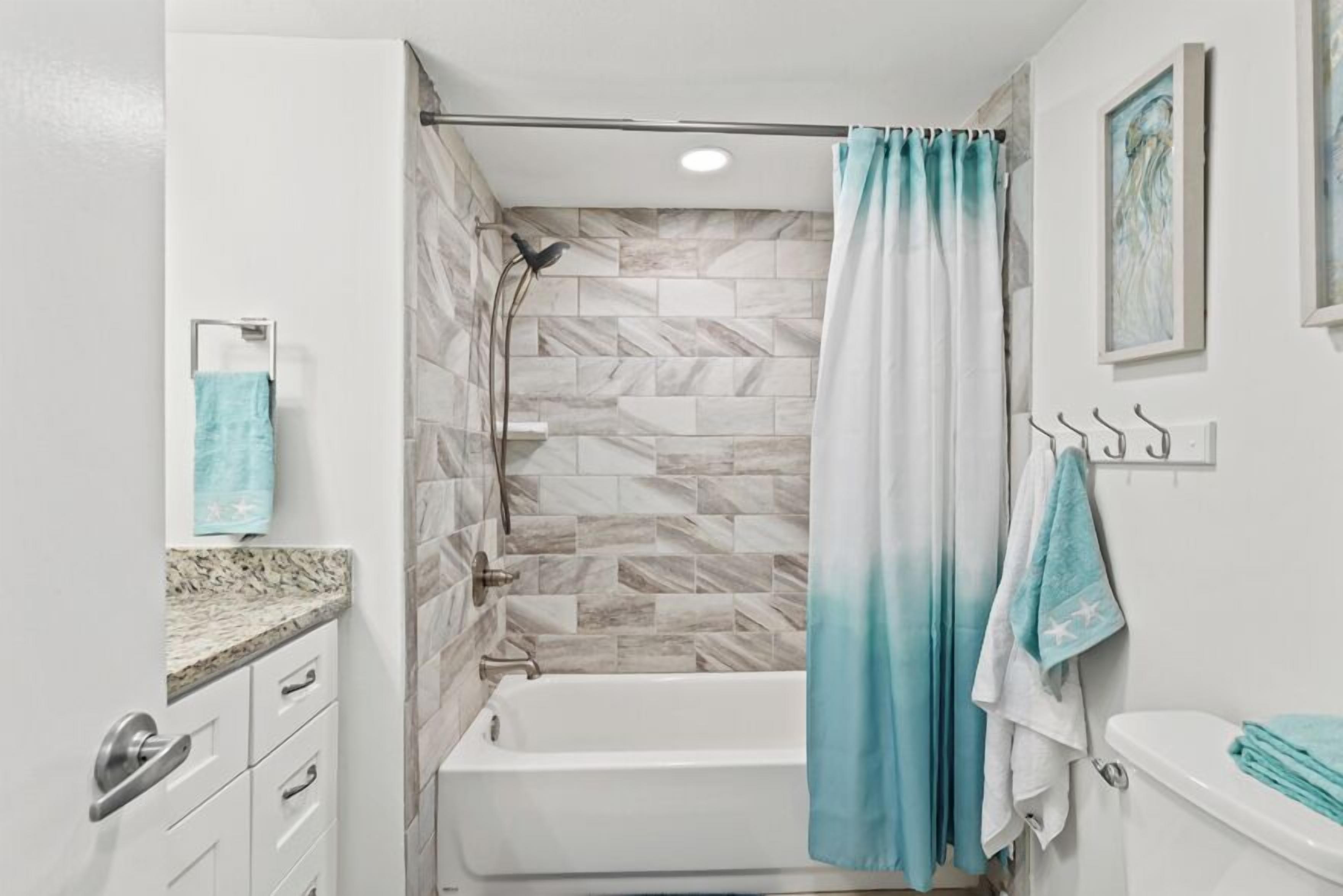 A bathroom with a shower, a bathtub, and a toilet.