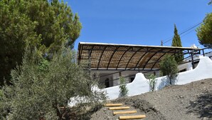 A modern building with a sloped roof and a pathway leading to the entrance.