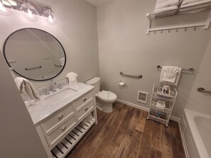 A modern bathroom with a vanity, toilet, and shower area. - Sea Angel - Stunning views from this ocean front home ! (Moclips)