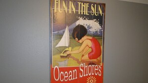 Een oude poster die Ocean Shores in Washington promoot, met aandacht voor gezinsvakanties.