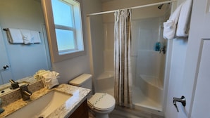 A bathroom with a sink, toilet, and shower area. - The Lake House - Best of both worlds (Ocean Shores)