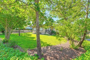 Enjoy a serene living space surrounded by mature trees and a well-maintained lawn.