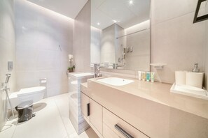 A modern bathroom with a large mirror, two sinks, a toilet, and a shower. - Modern 2BR w/ Sea View Balcony at Address JBR (Dubai)