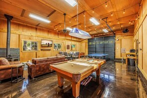 Relax and socialize in this inviting space with a pool table, billiards table, and cozy seating area.