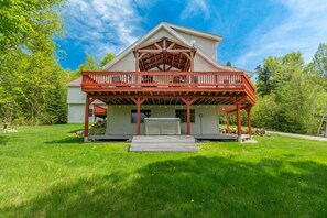 A two-story house with a covered porch and a small deck. - Mountain Views, Hot Tub near Hiking, Ski & Santa`s Village (Jefferson)
