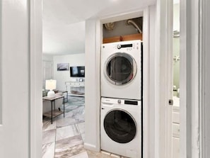 A laundry room with two stacked front-loading washing machines.