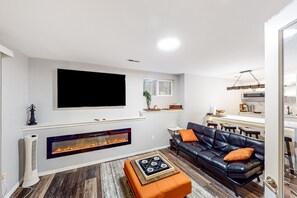TV, fireplace - Modern lower-level getaway with a fireplace, inviting patio & washer/dryer (Woodinville)