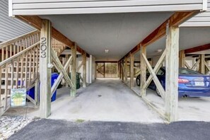 A covered parking area with a car parked inside.