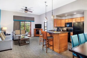 Relax in this spacious room with a sofa set, coffee table, and TV. Enjoy meals in the kitchenette with a refrigerator, microwave, and dining area.