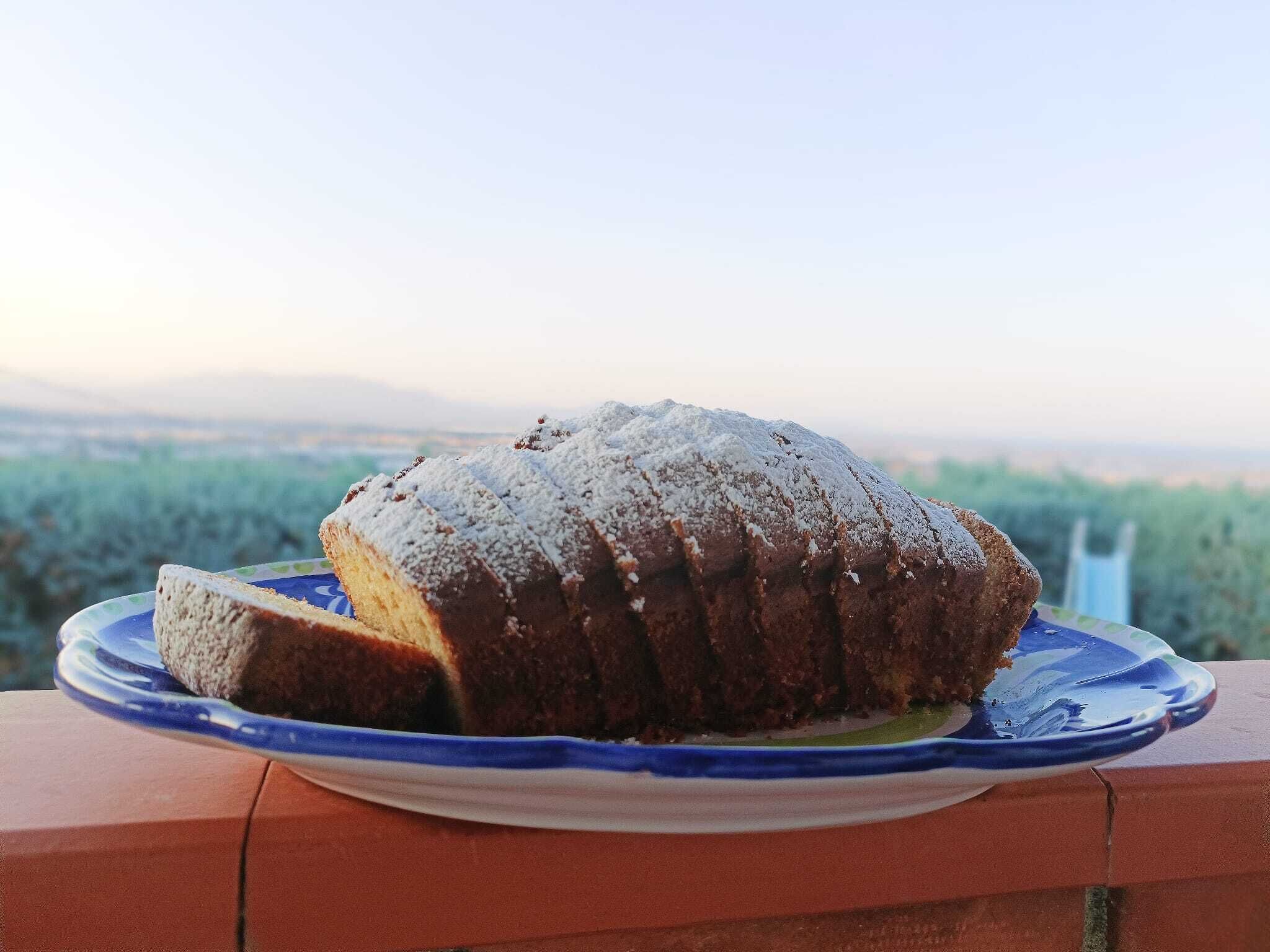 A loaf of bread on a plate with a scenic view in the background.