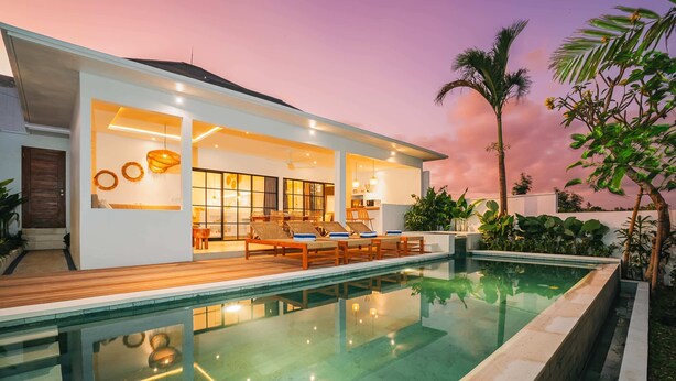 A modern house with a swimming pool, wooden deck, and outdoor seating area. - Villa L at Seseh (Munggu)