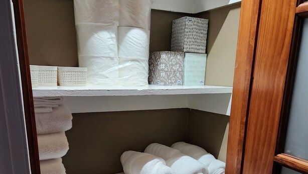 A storage closet with shelves holding neatly folded towels and linens. - 3bd Family-sized house, 5 minutes to National park, 12 minutes to the Capital. (Washington)
