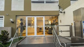 A hotel entrance with a glass door, a staircase, and a security camera. - Exclusive Panoramic Ocean View (1805) (Callao)